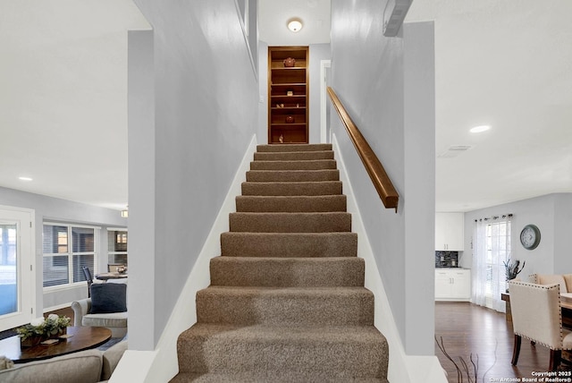 stairway with hardwood / wood-style flooring