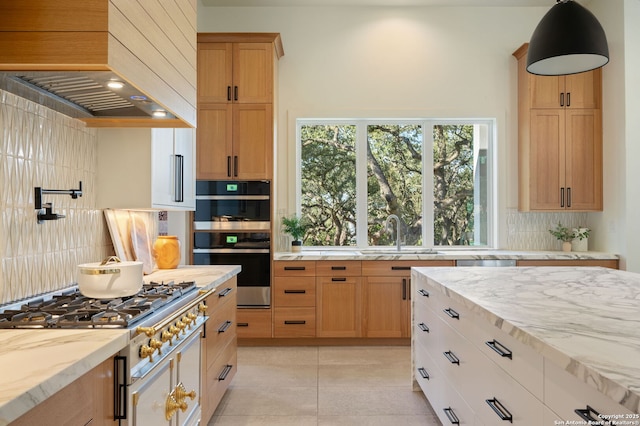 kitchen with light tile patterned floors, appliances with stainless steel finishes, a sink, custom exhaust hood, and backsplash