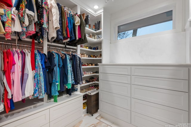 spacious closet with marble finish floor