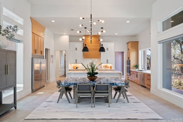 dining area featuring baseboards, light tile patterned flooring, a towering ceiling, and recessed lighting