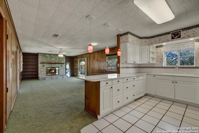 kitchen with pendant lighting, white cabinets, light colored carpet, white dishwasher, and plenty of natural light