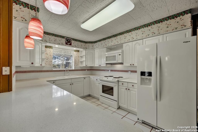 kitchen featuring light tile patterned flooring, white appliances, sink, and white cabinets