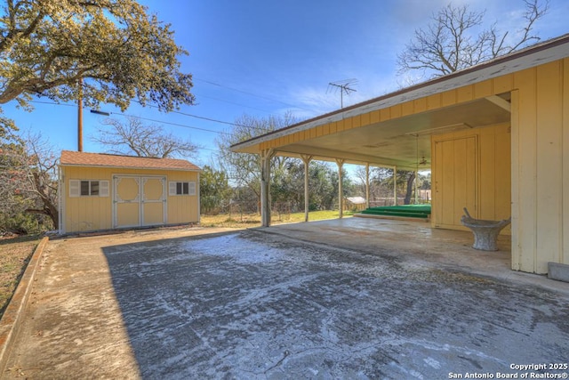 exterior space with a carport and a storage unit