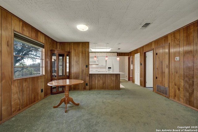 unfurnished dining area featuring carpet floors