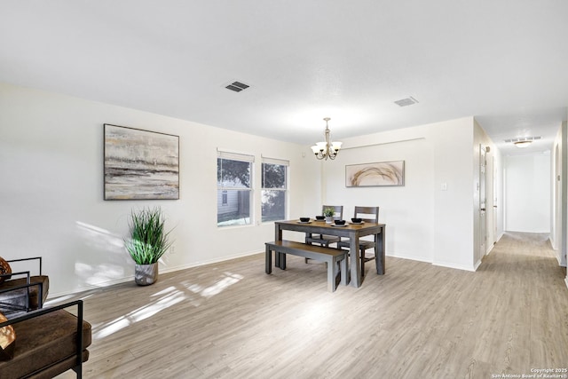 dining room featuring a chandelier and light hardwood / wood-style floors