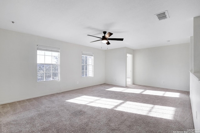 carpeted spare room with ceiling fan