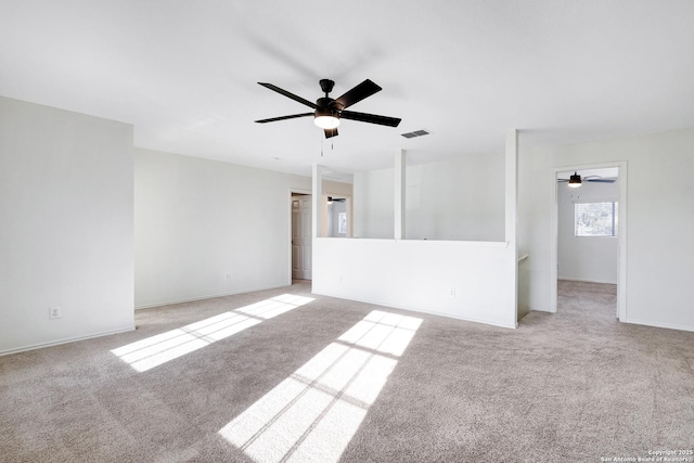 unfurnished room featuring ceiling fan and light colored carpet