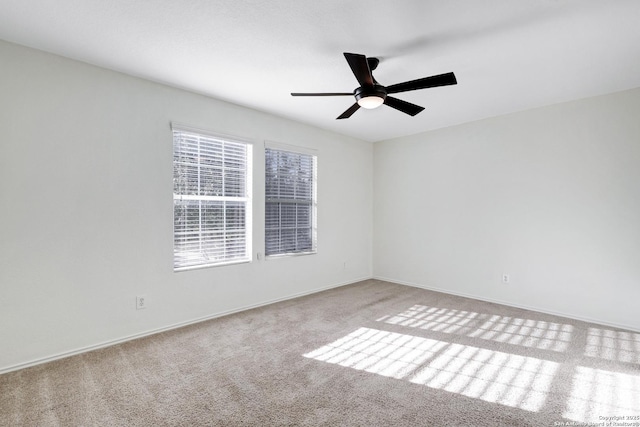 unfurnished room featuring ceiling fan and light carpet