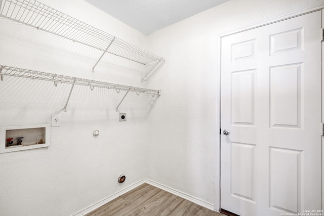 washroom with hookup for a gas dryer, wood-type flooring, washer hookup, and hookup for an electric dryer