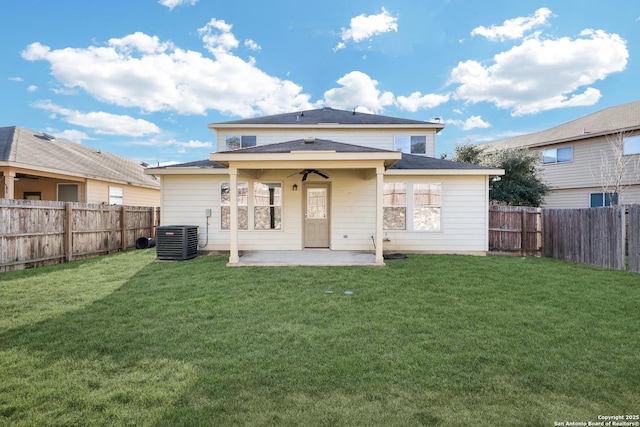 rear view of house with ceiling fan, a yard, central air condition unit, and a patio area