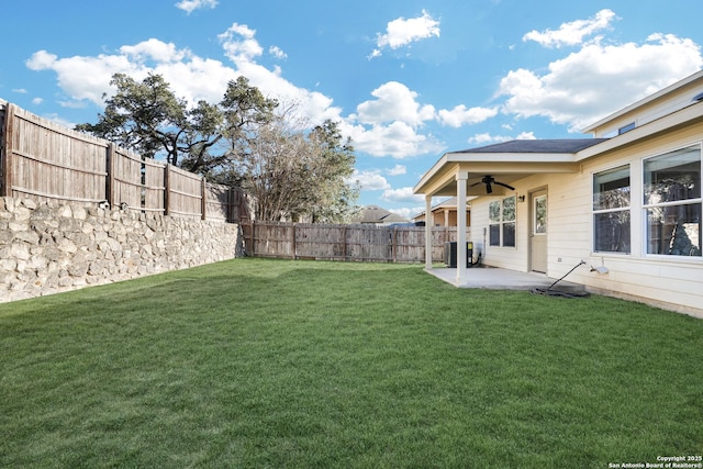 view of yard with central AC, a patio, and ceiling fan