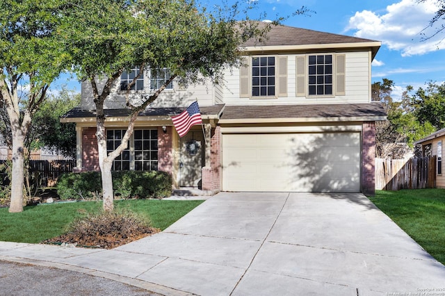 view of property with a garage and a front lawn