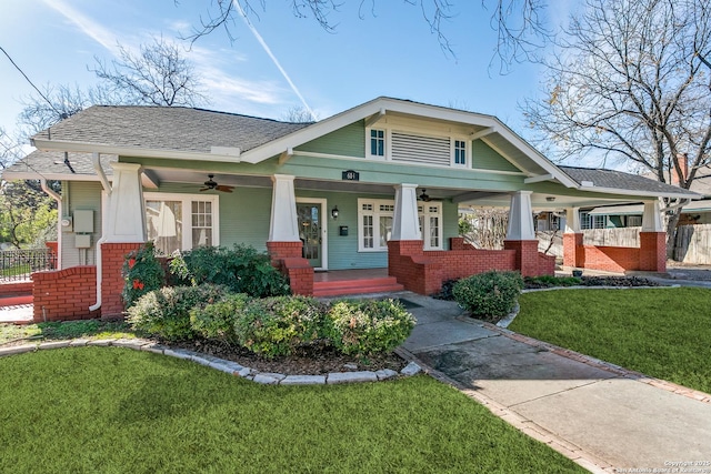 craftsman-style home with a front yard, ceiling fan, and a porch