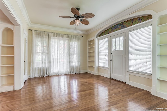 foyer entrance with crown molding, hardwood / wood-style floors, and ceiling fan