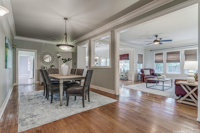 dining room featuring crown molding, wood-type flooring, and ceiling fan