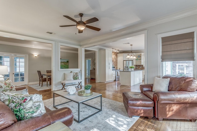 living room featuring crown molding and plenty of natural light