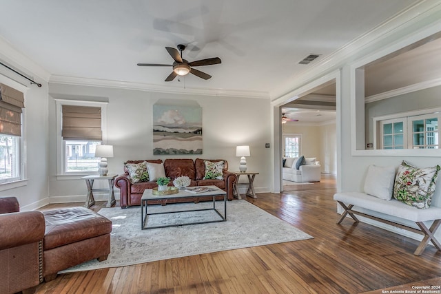 living room with hardwood / wood-style flooring, crown molding, a healthy amount of sunlight, and ceiling fan