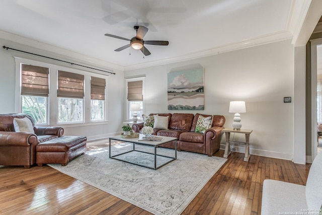 living room with hardwood / wood-style flooring, crown molding, and ceiling fan