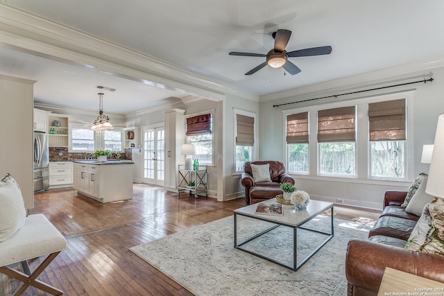 living room with crown molding, hardwood / wood-style floors, and ceiling fan