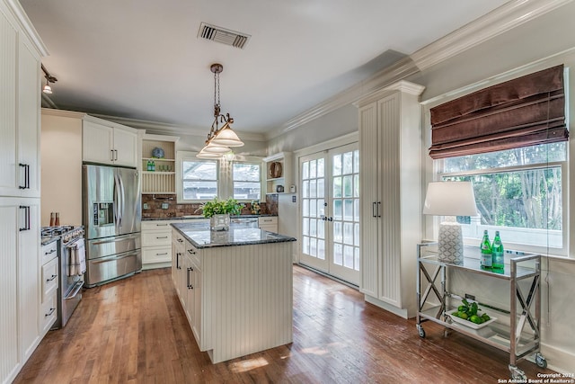 kitchen featuring french doors, appliances with stainless steel finishes, a center island, and white cabinets