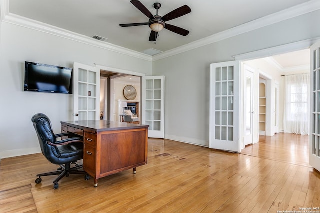 home office featuring ornamental molding, ceiling fan, light hardwood / wood-style floors, and french doors