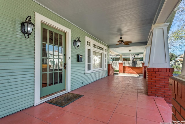 view of patio with ceiling fan and a porch