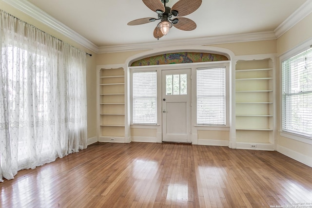 foyer with crown molding, ceiling fan, and wood-type flooring