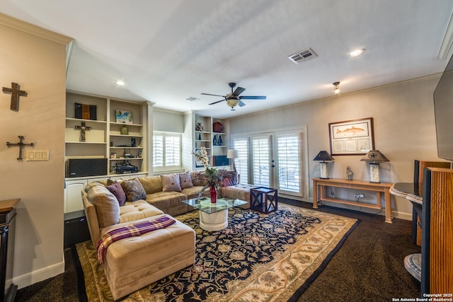 carpeted living room with ornamental molding and ceiling fan