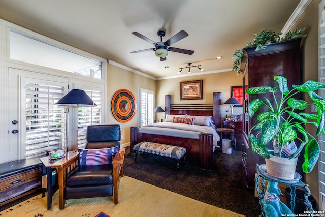 carpeted bedroom with crown molding and ceiling fan