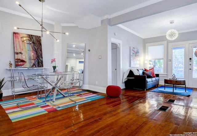 dining room featuring crown molding, wood-type flooring, and a chandelier