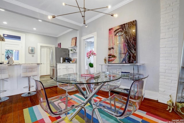 dining area with dark wood-type flooring and ornamental molding