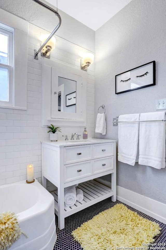 bathroom with vanity and a washtub