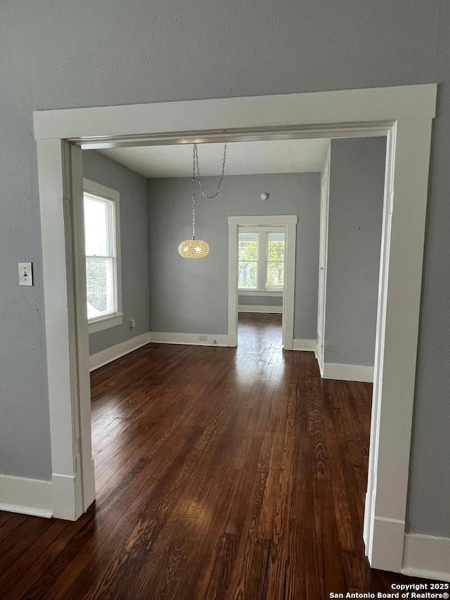 unfurnished dining area with dark hardwood / wood-style flooring