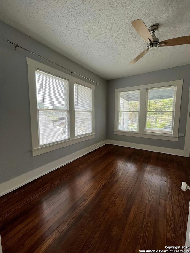 spare room featuring ceiling fan, wood-type flooring, and a textured ceiling