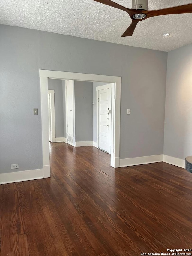 spare room featuring ceiling fan, dark hardwood / wood-style flooring, and a textured ceiling