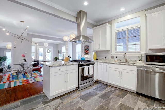 kitchen featuring sink, kitchen peninsula, island exhaust hood, stainless steel appliances, and white cabinets