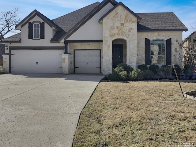 view of front of home with a garage and a front yard