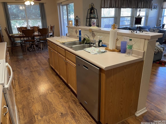 kitchen with dark hardwood / wood-style flooring, dishwasher, sink, and a wealth of natural light