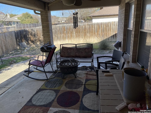 view of patio featuring ceiling fan and an outdoor fire pit