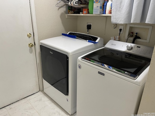 washroom with washing machine and clothes dryer