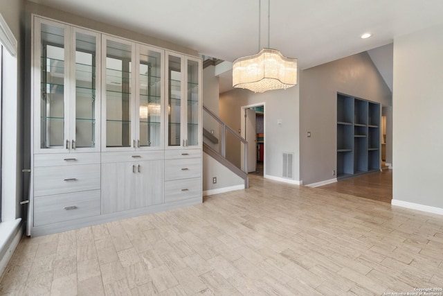 12519 Elm Manor St, San Antonio, TX 78230 - unfurnished dining area featuring baseboards, a chandelier, stairway, recessed lighting, and light wood-style floors