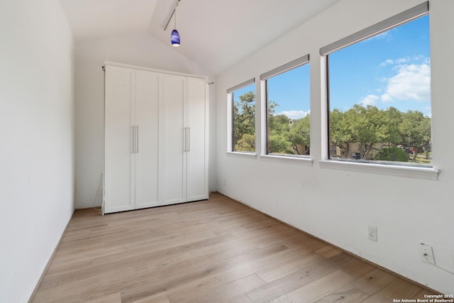 12519 Elm Manor St, San Antonio, TX 78230 - unfurnished bedroom featuring light wood-style floors, vaulted ceiling, and a closet