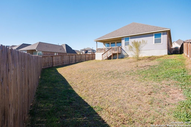 rear view of property featuring a lawn