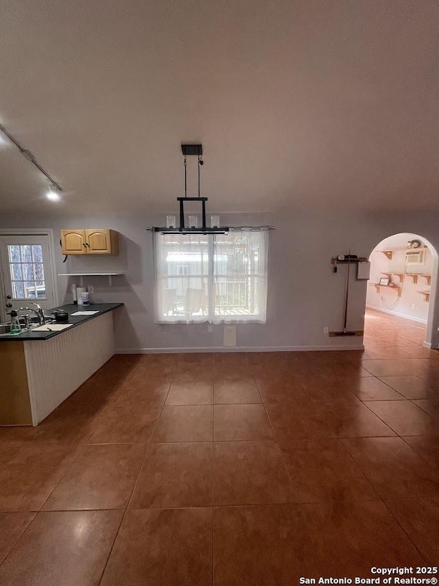 kitchen with pendant lighting, sink, tile patterned flooring, and rail lighting