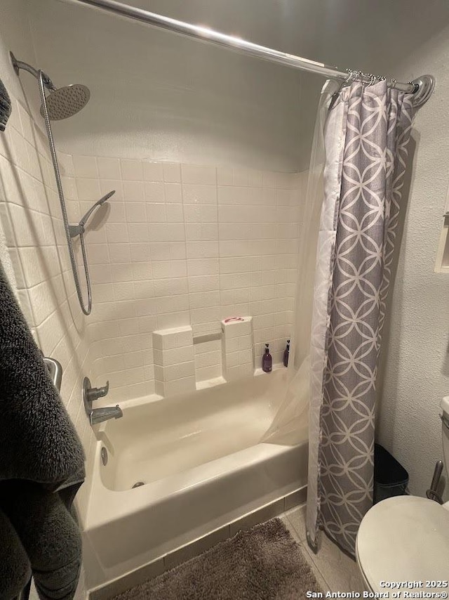 bathroom featuring shower / tub combo with curtain and toilet