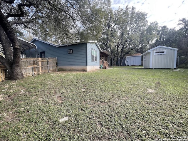 view of yard featuring a carport and a shed