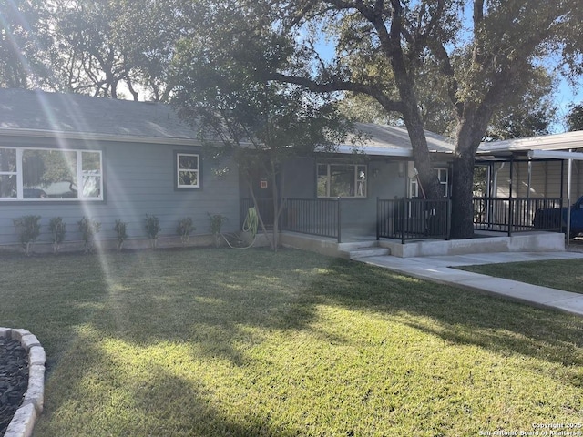 rear view of house featuring a yard and a porch