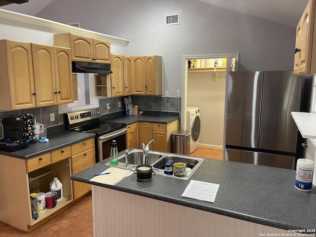 kitchen with light tile patterned flooring, sink, tasteful backsplash, stainless steel appliances, and washer and clothes dryer