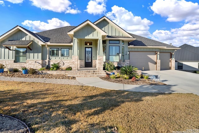 craftsman-style house featuring a garage and a front lawn