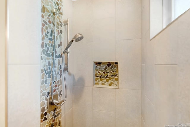 bathroom with tiled shower